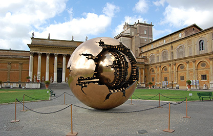 Golden globe in front of buildings