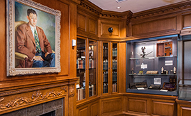View of Trent Collection room, including large portrait and shelves of books and historical objects