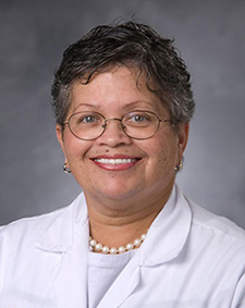 Brenda Armstrong headshot, smiling in white coat