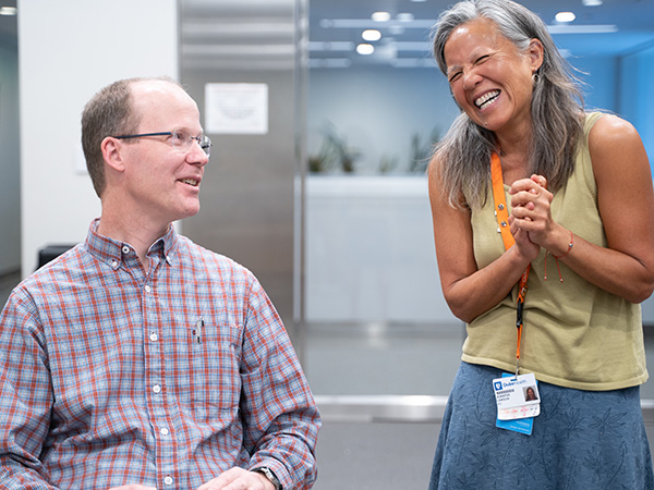 Drs. Warren Kinghorn and Jennifer Lawson talking, laughing