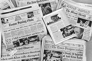 Newspapers showing headlines of 1979 Greensboro Massacre